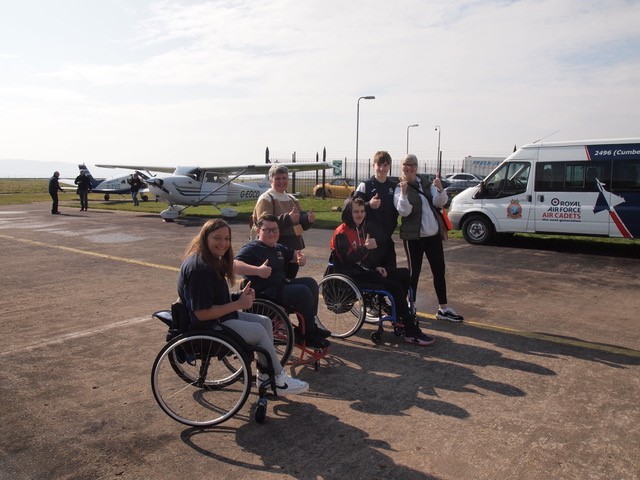 Wheelchair users on airfield.